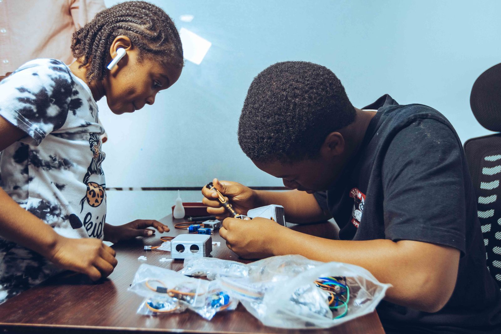 Young learners building a robotics kit in a hands-on session